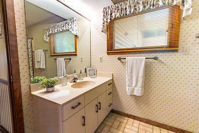 a bathroom with a sink vanity and a mirror