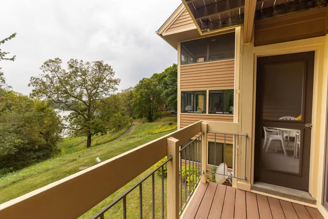 a view of a balcony with wooden floor and fence