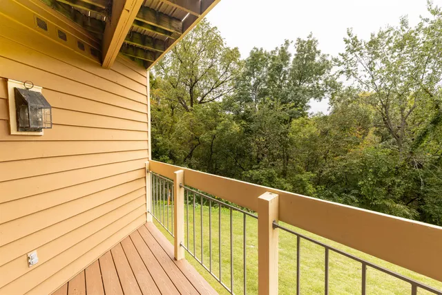 a view of a balcony with wooden floor