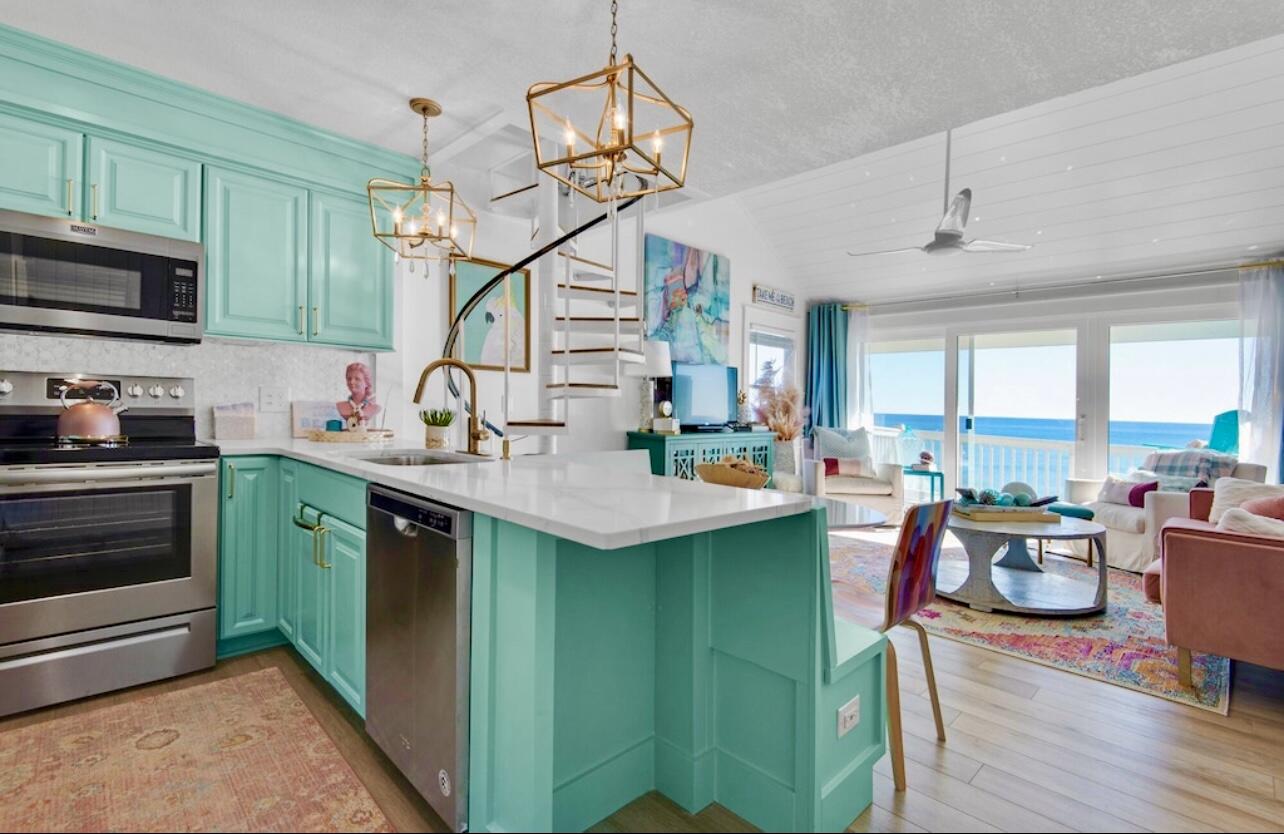 32461 East County Highway 30A, Unit 17 Inlet Beach, FL 32461 - Photo 3 of 53 a kitchen with kitchen island stainless steel appliances a sink stove and cabinets
