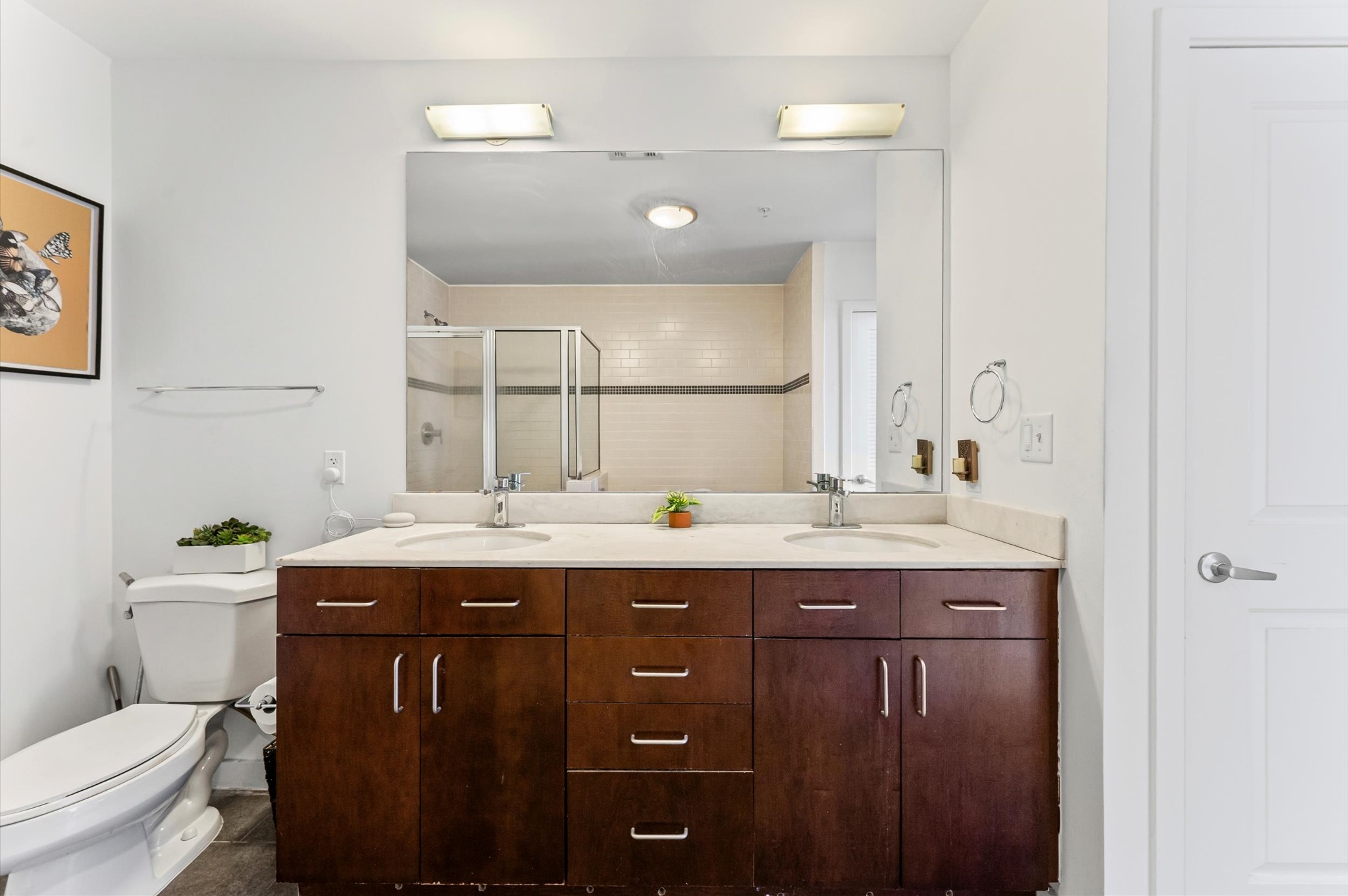5925 Almeda Road, Unit 11315 Houston, TX 77004 - Photo 16 of 31 a bathroom with a granite countertop sink a toilet and a mirror