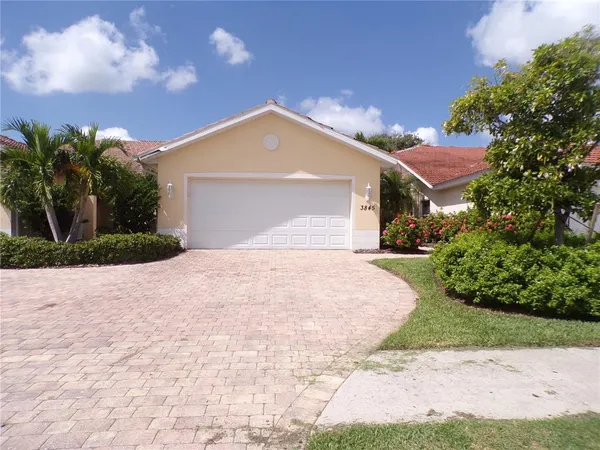 a front view of a house with a yard and a garage