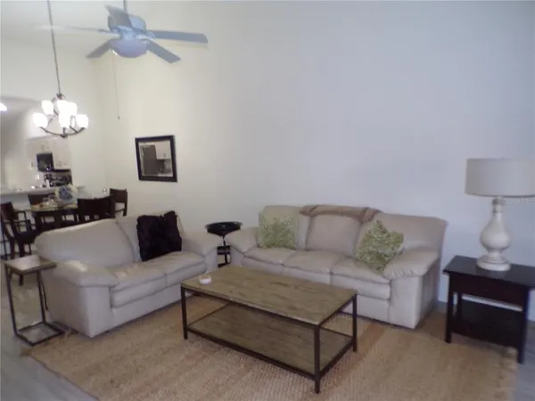 a living room with furniture a lamp and a chandelier