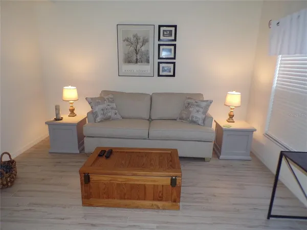 a living room with furniture and a lamp