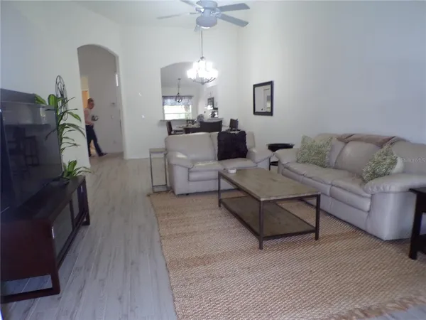 a living room with furniture and a chandelier