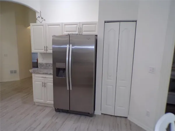 a kitchen with metallic refrigerator freezer and a dishwasher