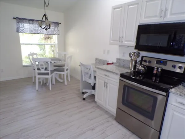 a kitchen with stainless steel appliances a stove a sink and a microwave