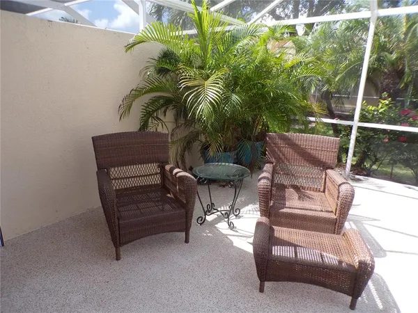 a building outdoor space with patio furniture and potted plants