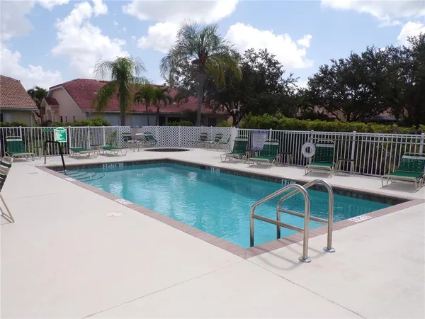 a view of a patio with a table chairs and a fire pit