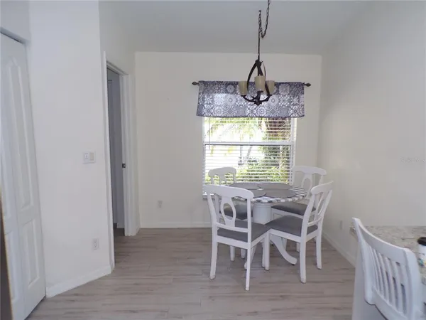 a dining room with furniture window and wooden floor