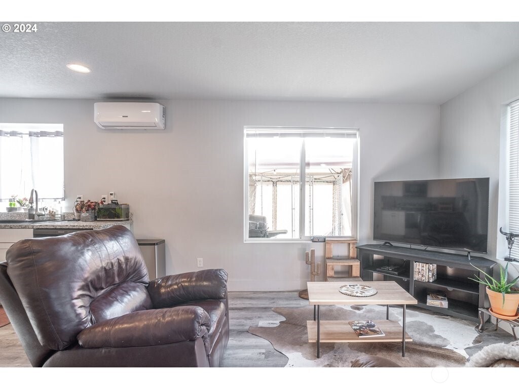213 Oak Street Winlock, WA 98596 - Photo 19 of 32 a living room with furniture and a flat screen tv