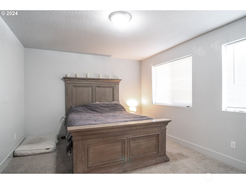 213 Oak Street Winlock, WA 98596 - Photo 23 of 32 a bedroom with a bed and a window