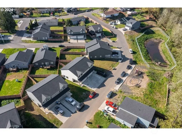 an aerial view of residential house with outdoor space and parking