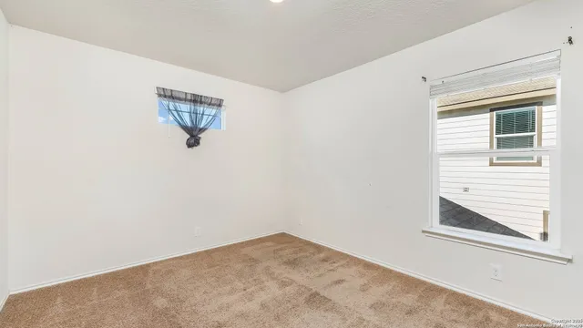 a view of a small space with wooden floor and a window