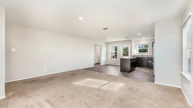 an empty room with a kitchen and a kitchen view