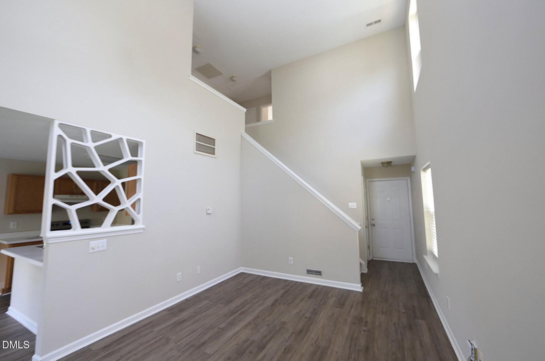 9904 Treymore Drive Raleigh, NC 27617 - Photo 3 of 14 a view of a hallway with wooden floor and entryway