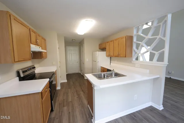 a kitchen with stainless steel appliances a sink dishwasher stove refrigerator and microwave