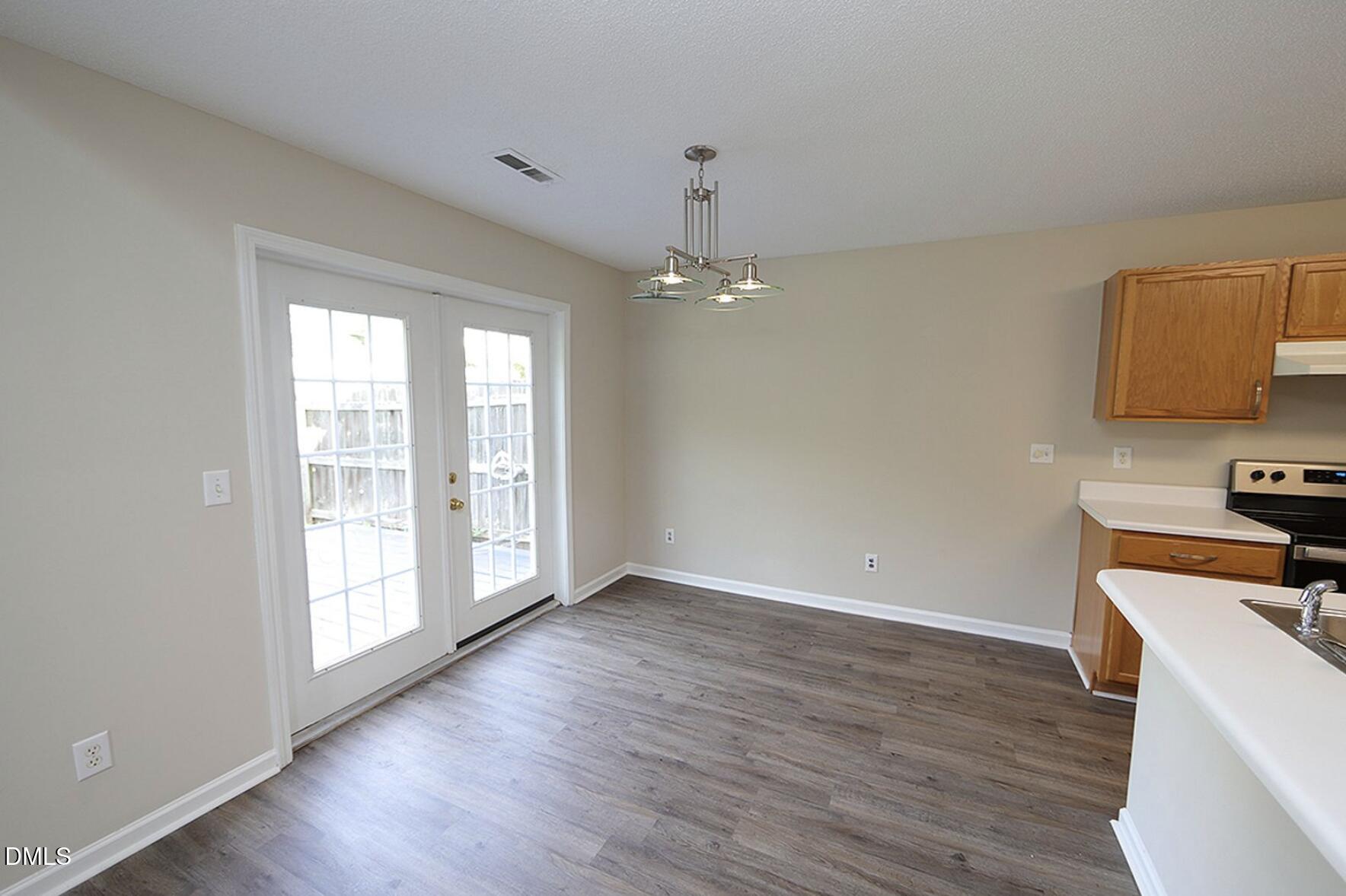 9904 Treymore Drive Raleigh, NC 27617 - Photo 5 of 14 wooden floor in an empty room with a window