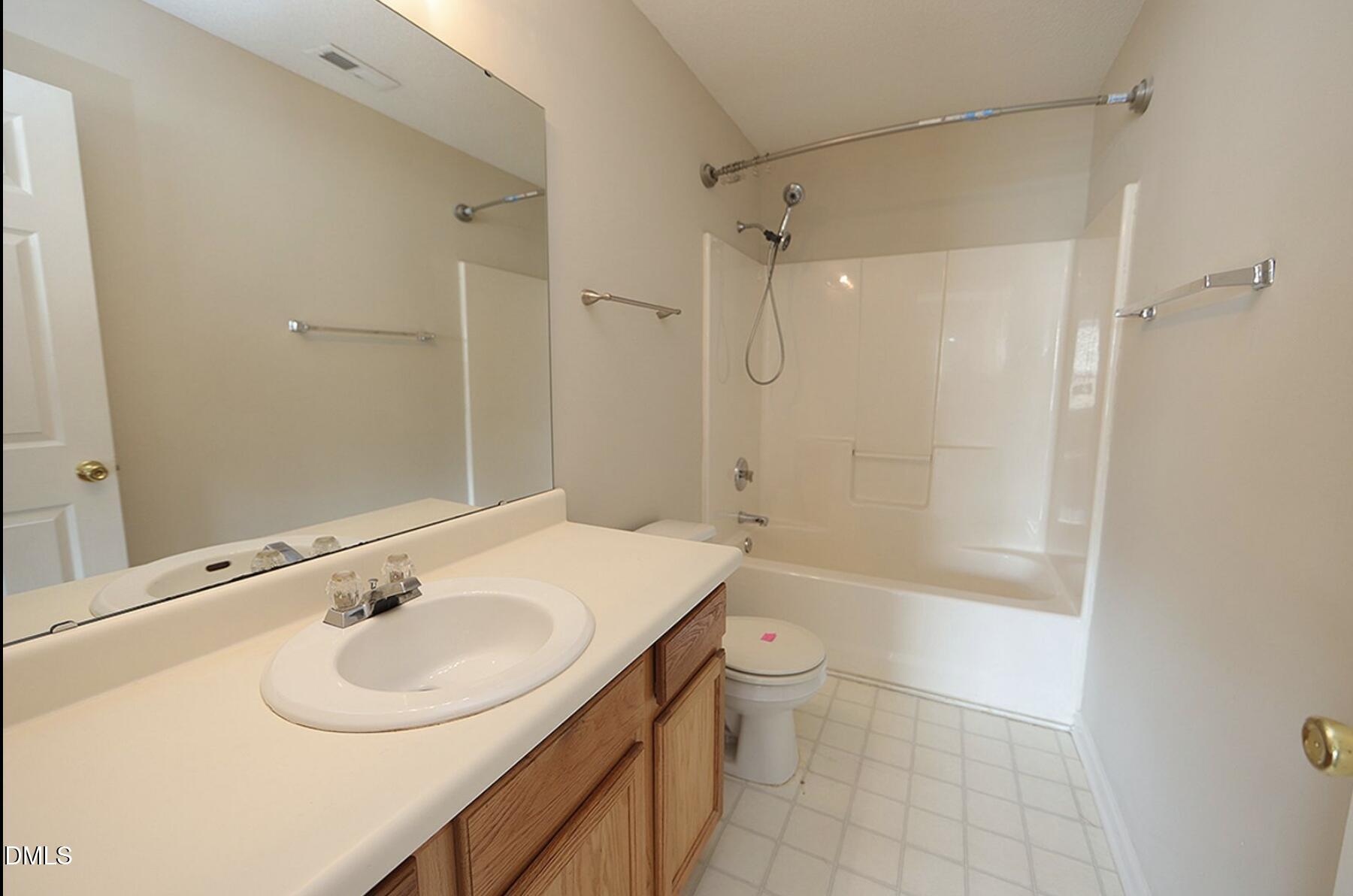9904 Treymore Drive Raleigh, NC 27617 - Photo 7 of 14 a bathroom with a sink toilet and shower