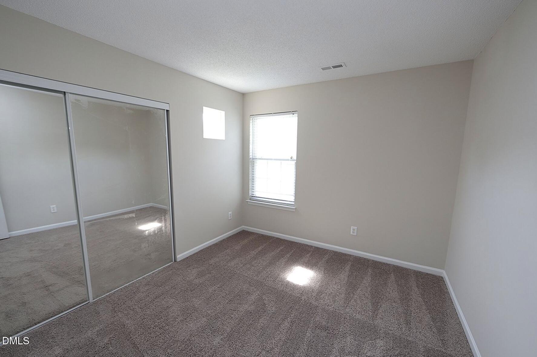9904 Treymore Drive Raleigh, NC 27617 - Photo 9 of 14 a view of an empty room with a window