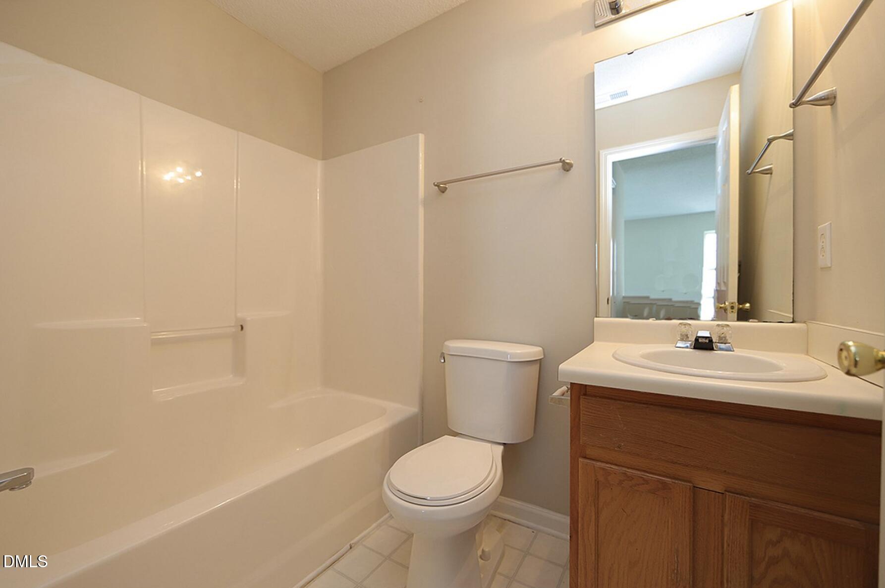 9904 Treymore Drive Raleigh, NC 27617 - Photo 10 of 14 a bathroom with a toilet a sink and a bathtub