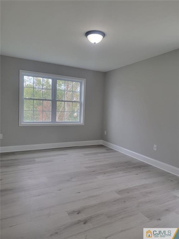 32 Middle Hill Road Colonia, NJ 07067 - Photo 15 of 21 a view of an empty room with wooden floor and a window