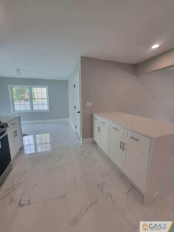 32 Middle Hill Road Colonia, NJ 07067 - Photo 5 of 21 a view of an empty room with window and stairs