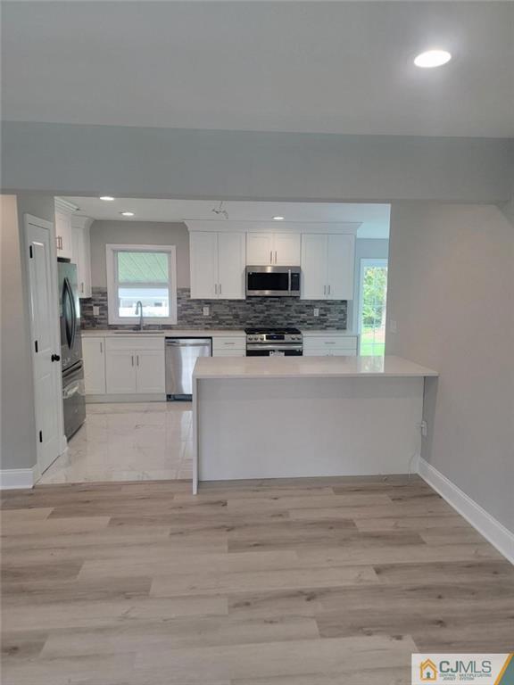 32 Middle Hill Road Colonia, NJ 07067 - Photo 8 of 21 a view of kitchen with microwave stove refrigerator and cabinets