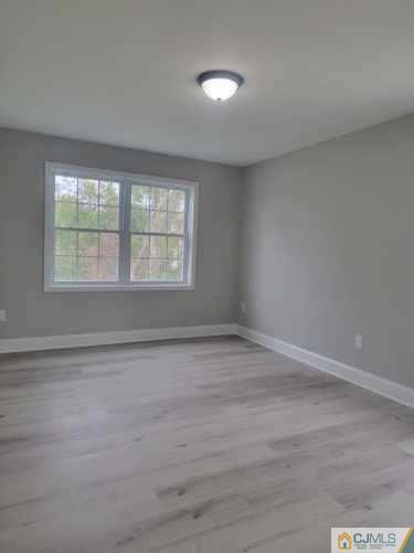 32 Middle Hill Road Colonia, NJ 07067 - Photo 9 of 21 a view of an empty room with wooden floor and a window