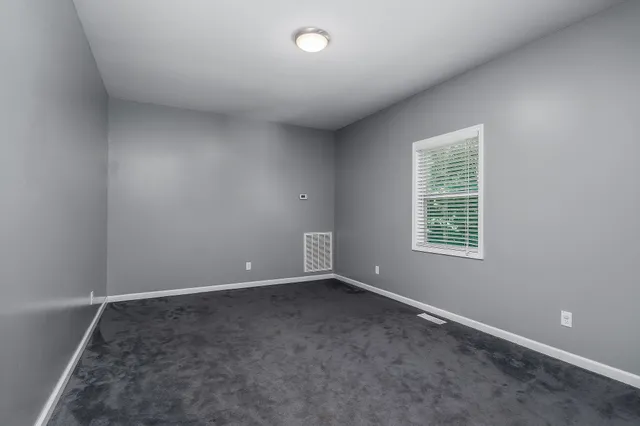 an empty room with a empty space and window