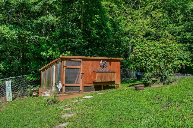 a view of backyard with deck and garden