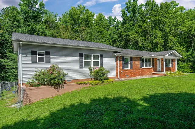 a front view of house with yard and green space