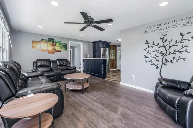 a living room with furniture and a wooden floor