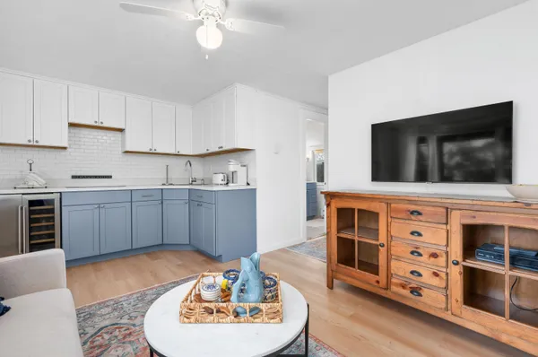 a living room with stainless steel appliances kitchen island granite countertop a stove a sink and a microwave