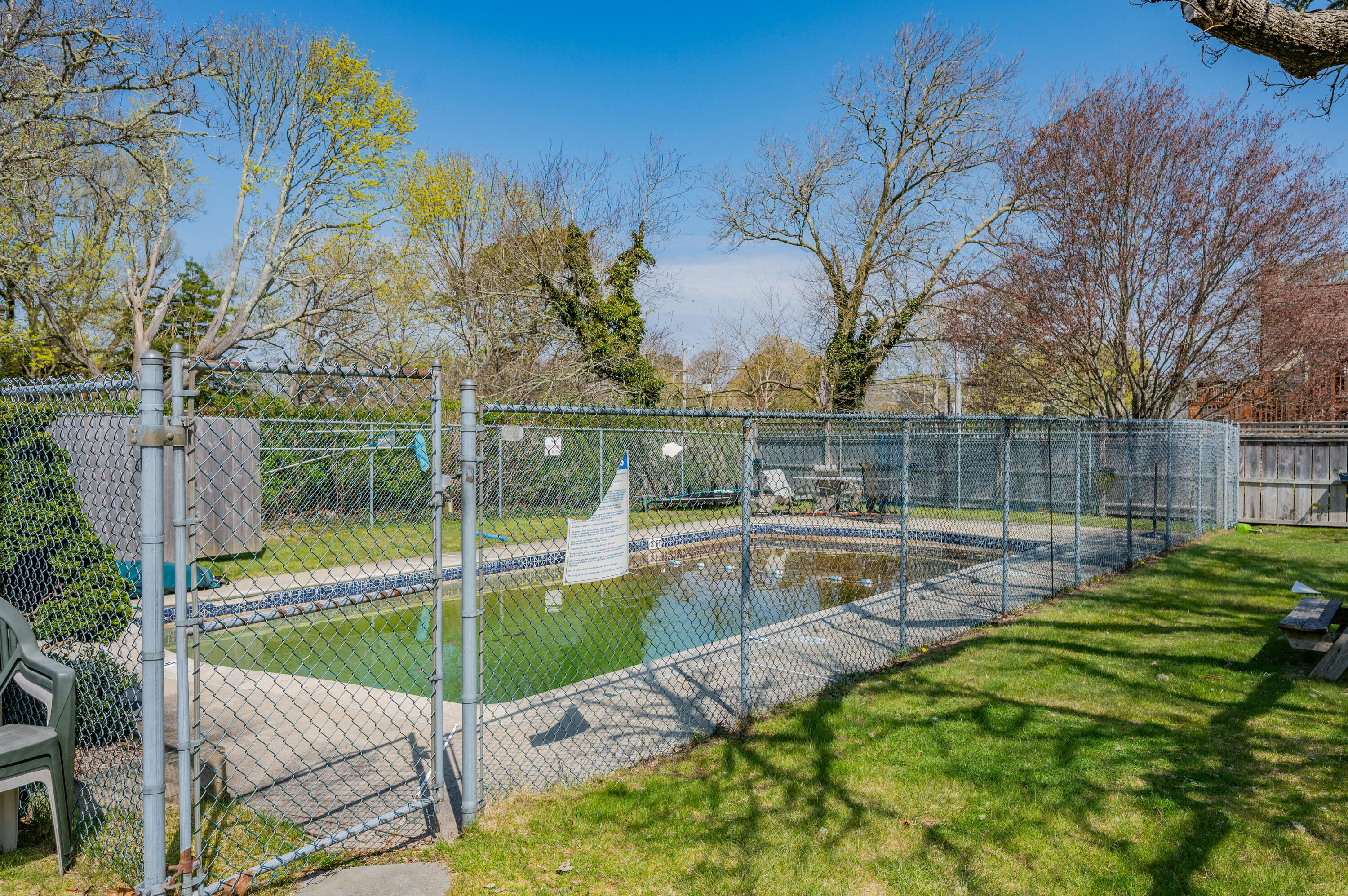 405 Lower County Road, Unit 23C Harwich Port, MA 02646 - Photo 11 of 17 a view of backyard with swimming pool and outdoor seating