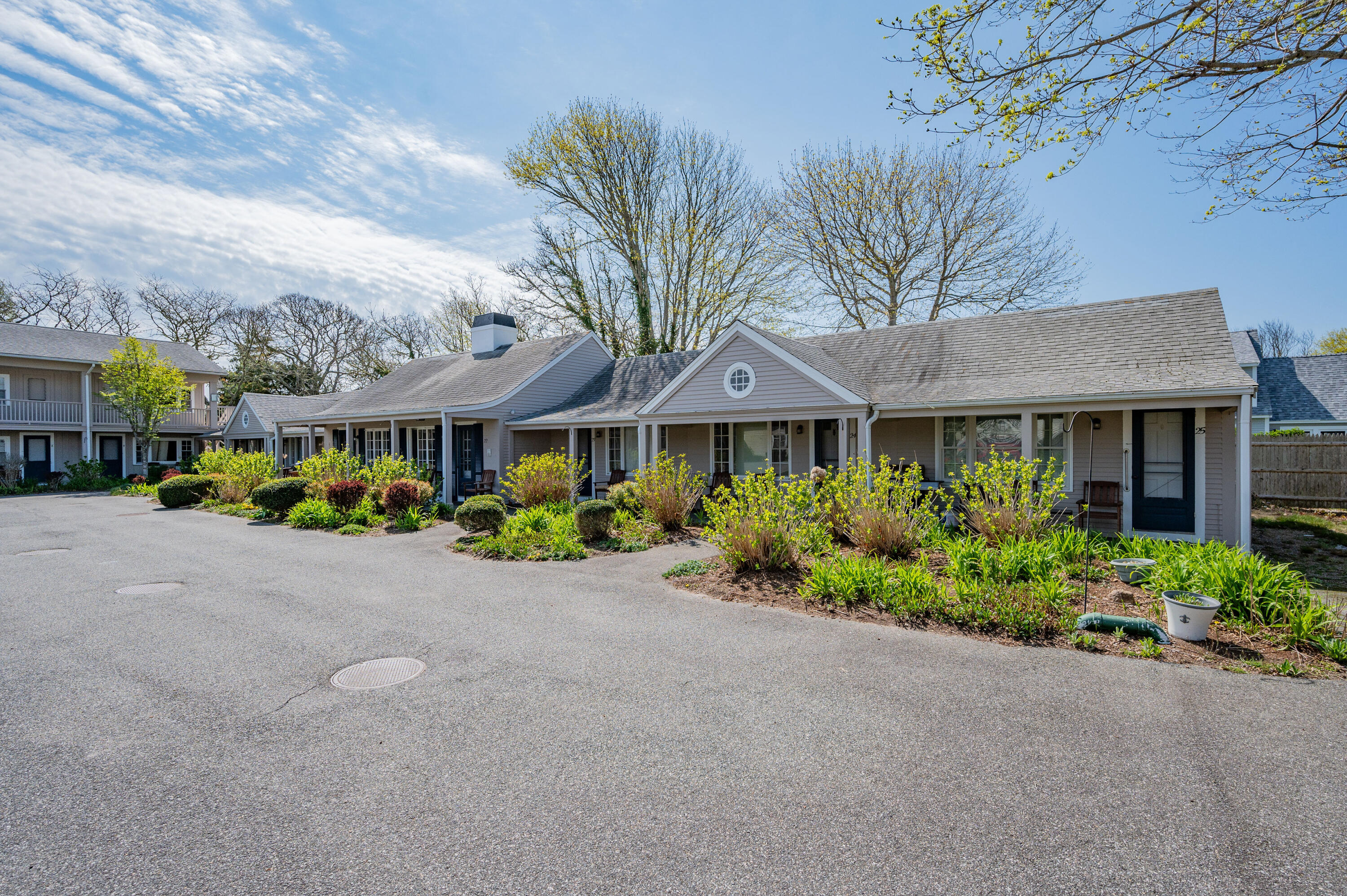 405 Lower County Road, Unit 23C Harwich Port, MA 02646 - Photo 13 of 17 a front view of a house with garden