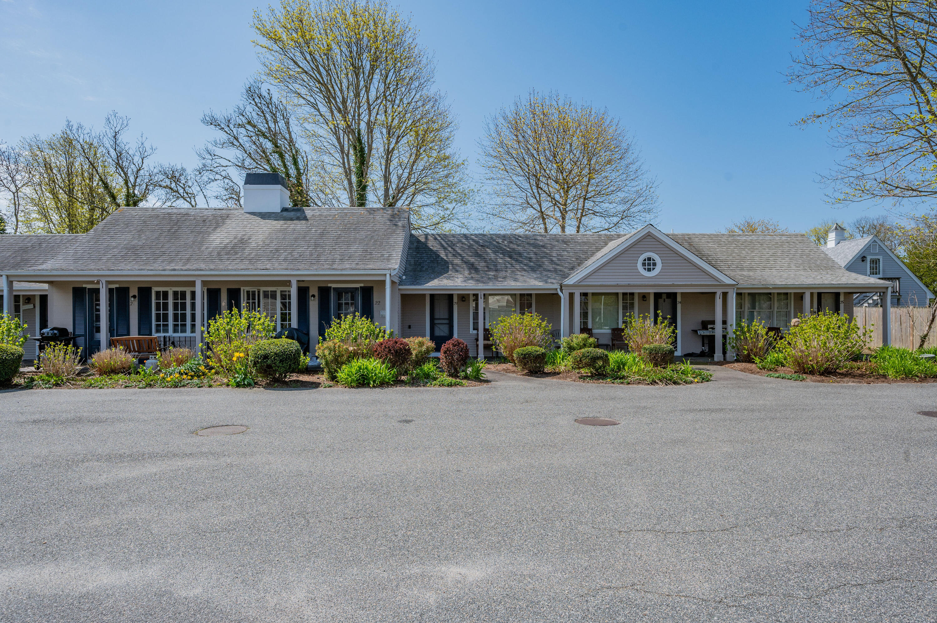 405 Lower County Road, Unit 23C Harwich Port, MA 02646 - Photo 15 of 17 a front view of a house with yard and green space