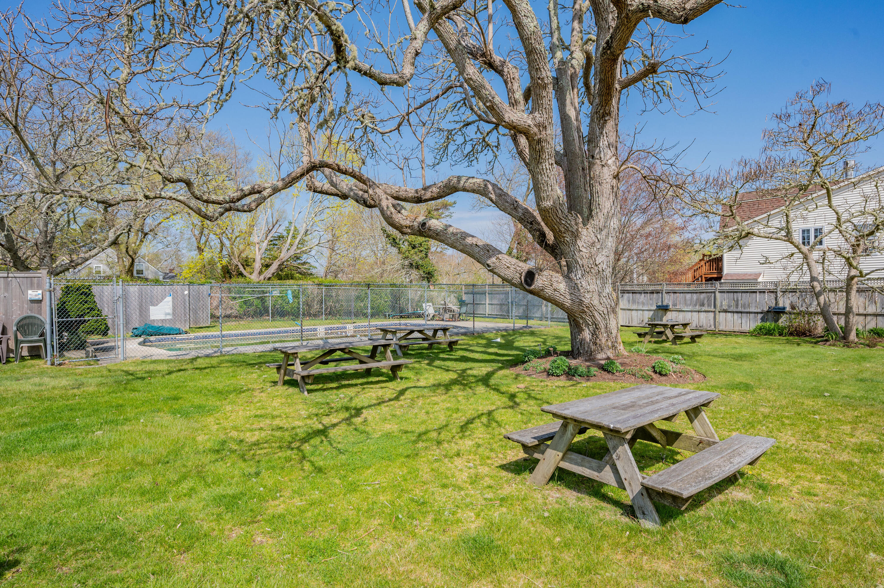 405 Lower County Road, Unit 23C Harwich Port, MA 02646 - Photo 9 of 17 a backyard of a house with table and chairs