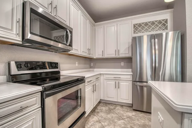 an aerial view of residential houses with outdoor space and lake view