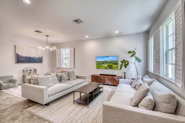 a kitchen with a refrigerator and white cabinets