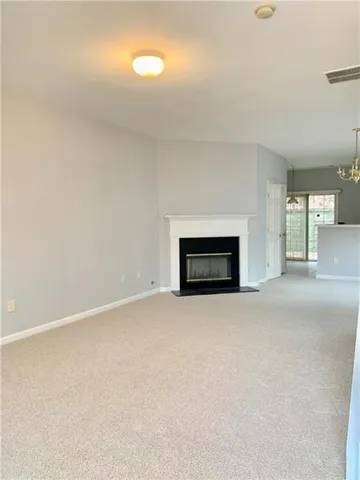 a view of empty room with a fireplace