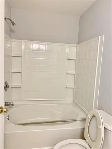 a bathroom with a toilet and a bathtub