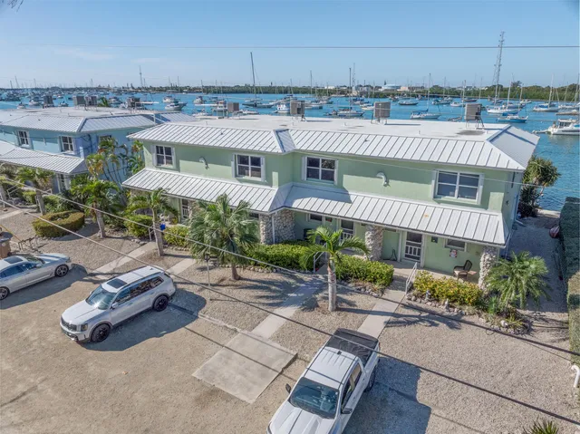 a kitchen with stainless steel appliances granite countertop a sink and dishwasher a refrigerator with wooden cabinets