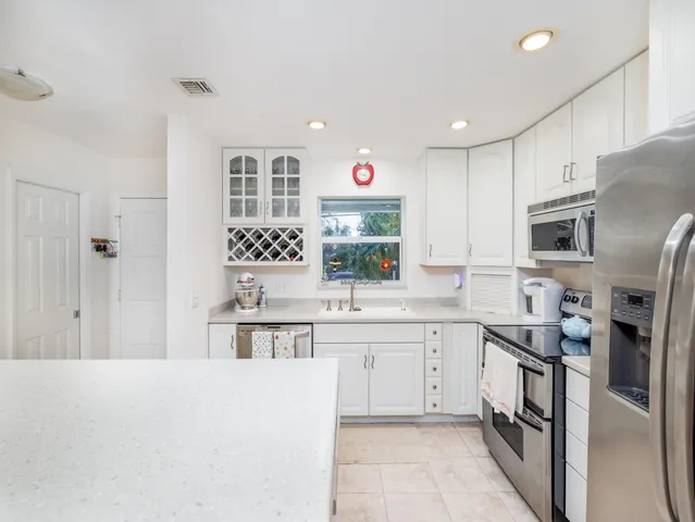a bedroom with a bed a large window with the outer view