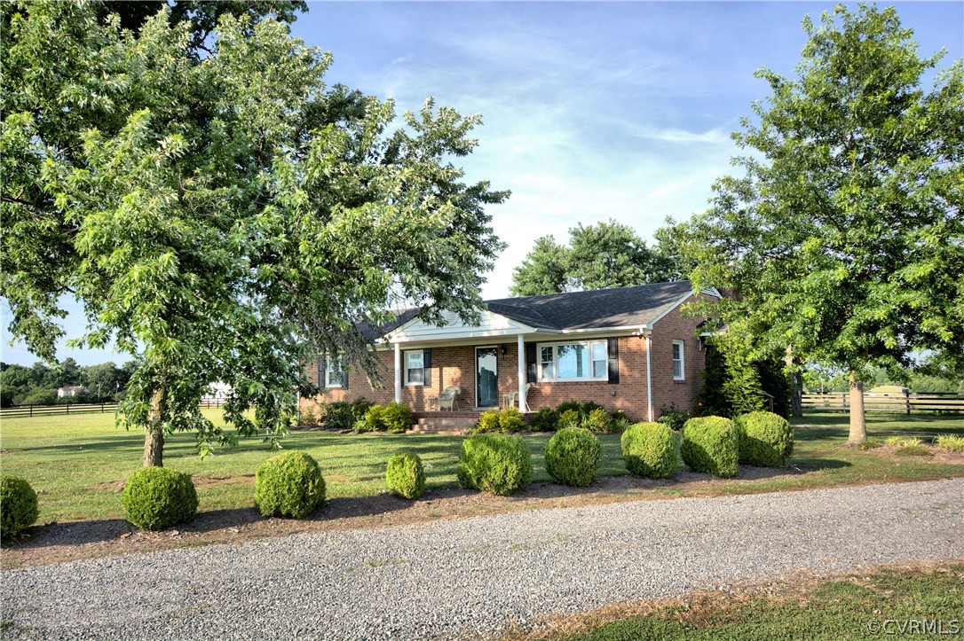 13480 Independence Road Ashland, VA 23005 - Photo 3 of 28 a front view of a house with a garden and trees