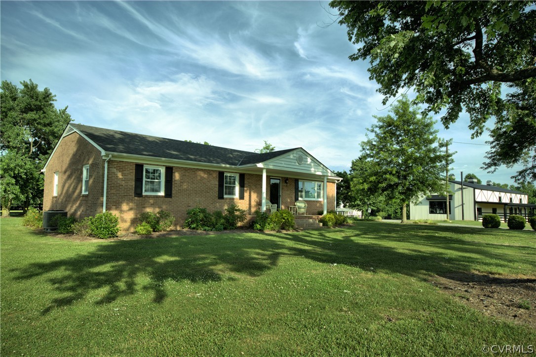 13480 Independence Road Ashland, VA 23005 - Photo 6 of 28 a front view of a house with a garden