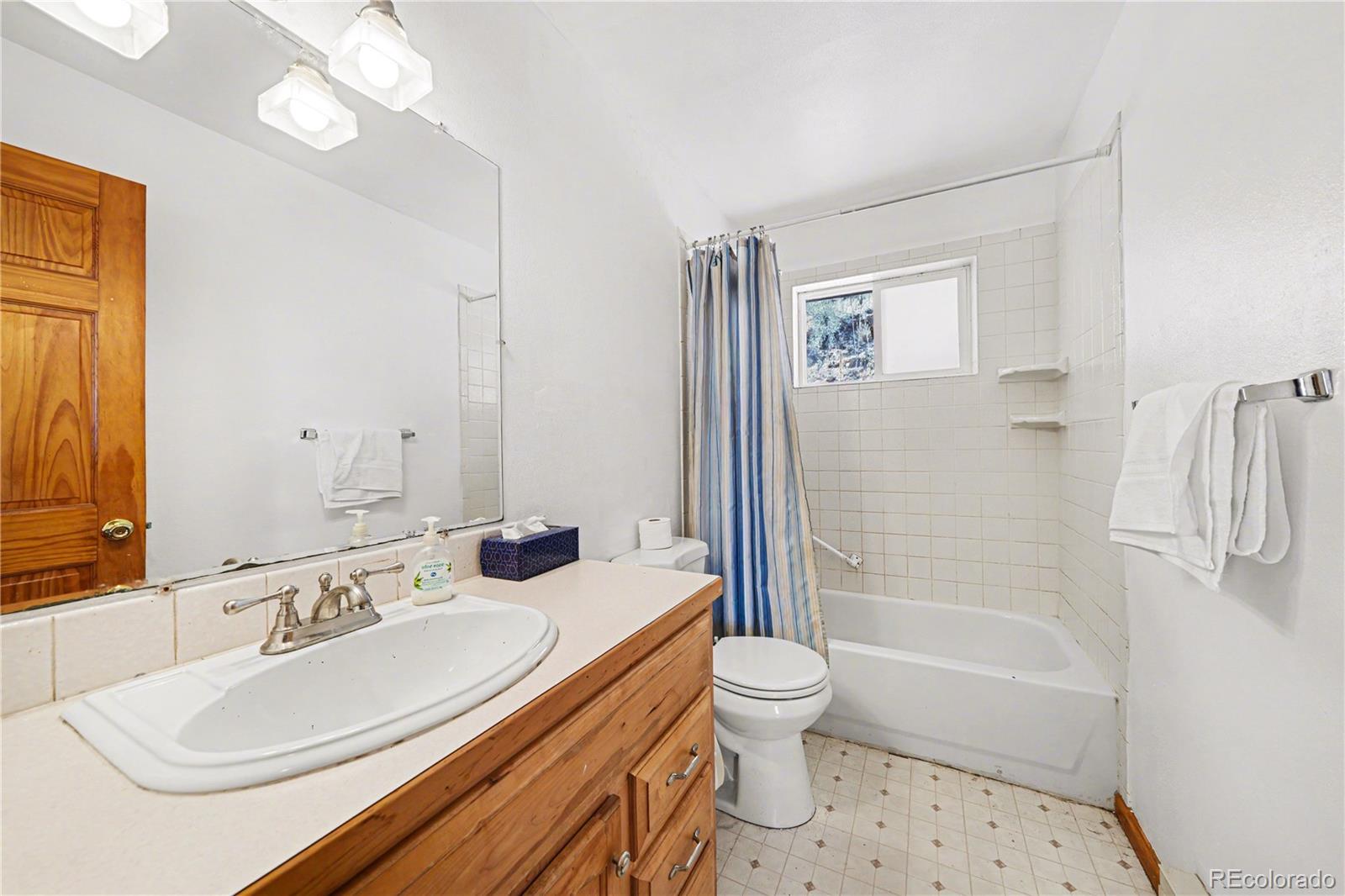 319 Springmeadow Way Red Feather Lakes, CO 80545 - Photo 12 of 30 a bathroom with a sink a toilet and shower