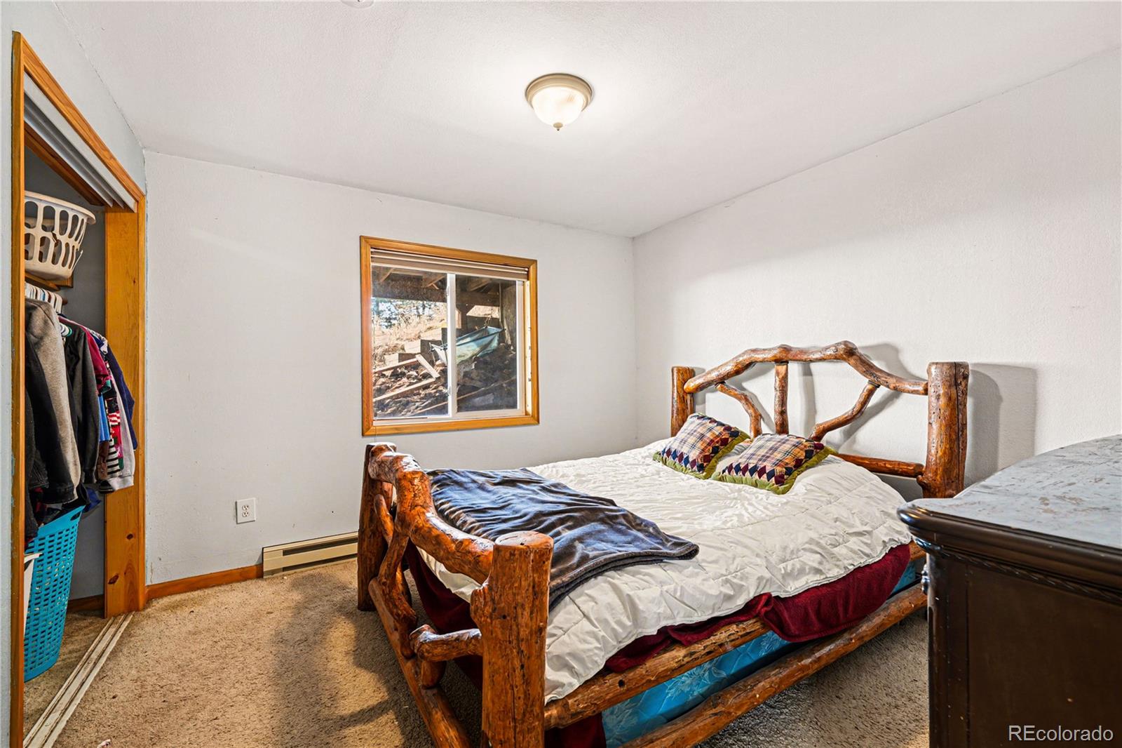 319 Springmeadow Way Red Feather Lakes, CO 80545 - Photo 15 of 30 a bedroom with a bed and a window