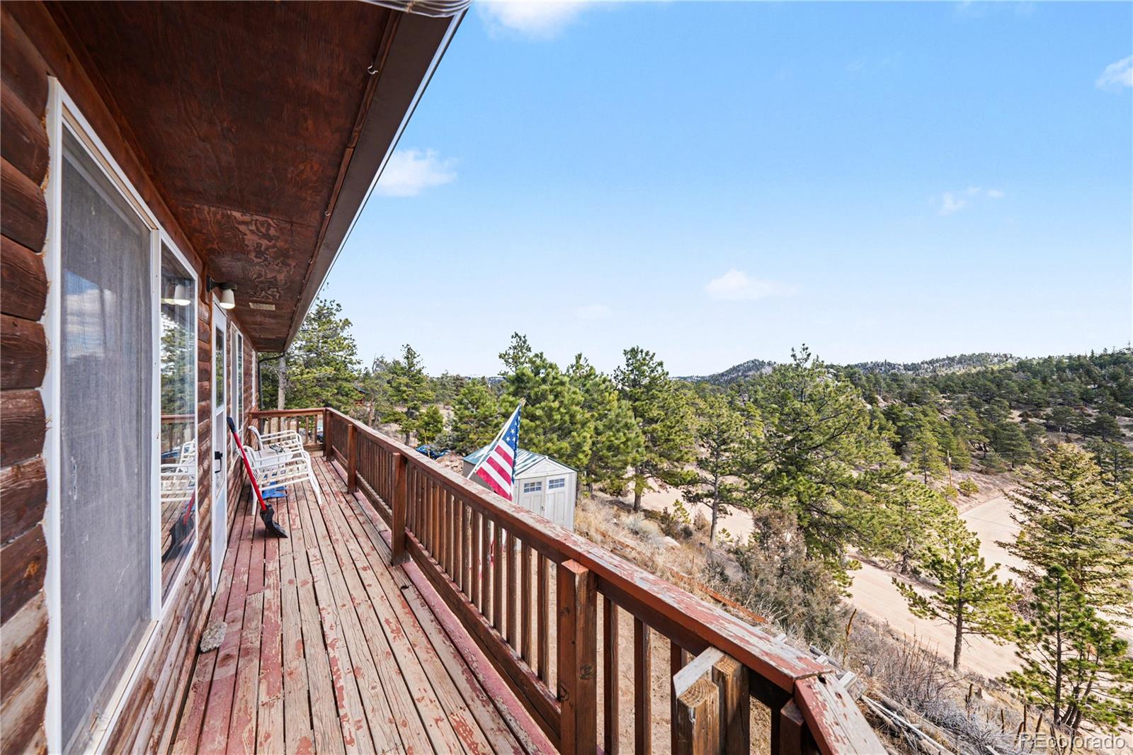 319 Springmeadow Way Red Feather Lakes, CO 80545 - Photo 2 of 30 a view of a balcony with wooden floor and fence