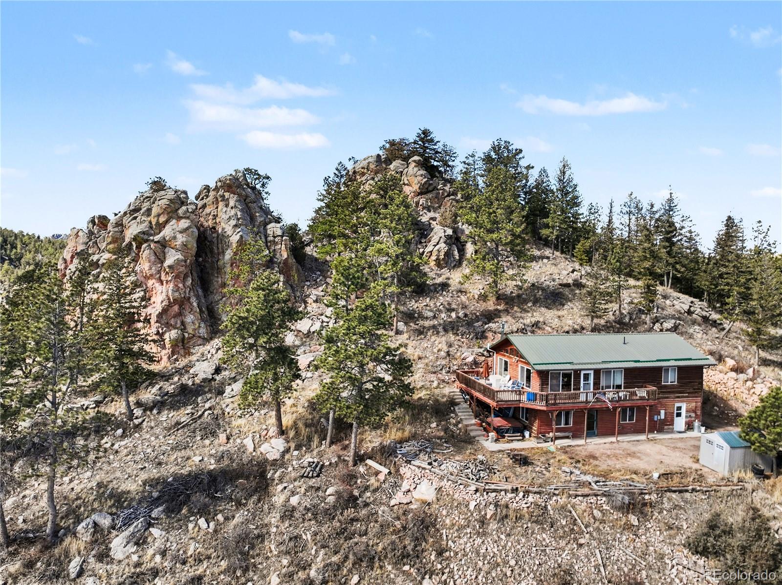 319 Springmeadow Way Red Feather Lakes, CO 80545 - Photo 26 of 30 a view of a big house with a big yard and large trees